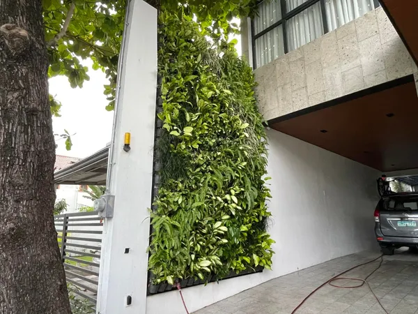 Vertical green wall on exterior facade with mixed tropical plants at BF Homes Parañaque
