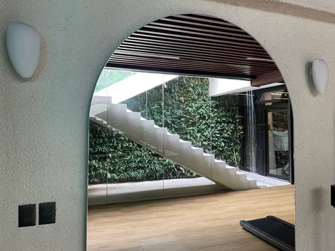 Indoor green wall behind floating staircase in Forbes Park residence